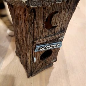 Outhouse bird feeder shaped like an outhouse and has the words occupied on door